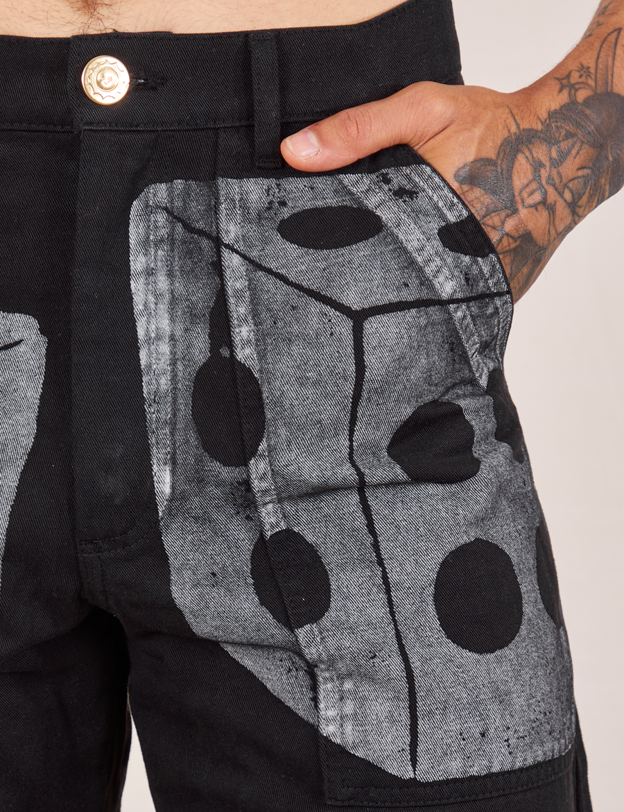 Front pocket close up of Icon Work Pants in Dice. Jesse has their hand in the pocket.
