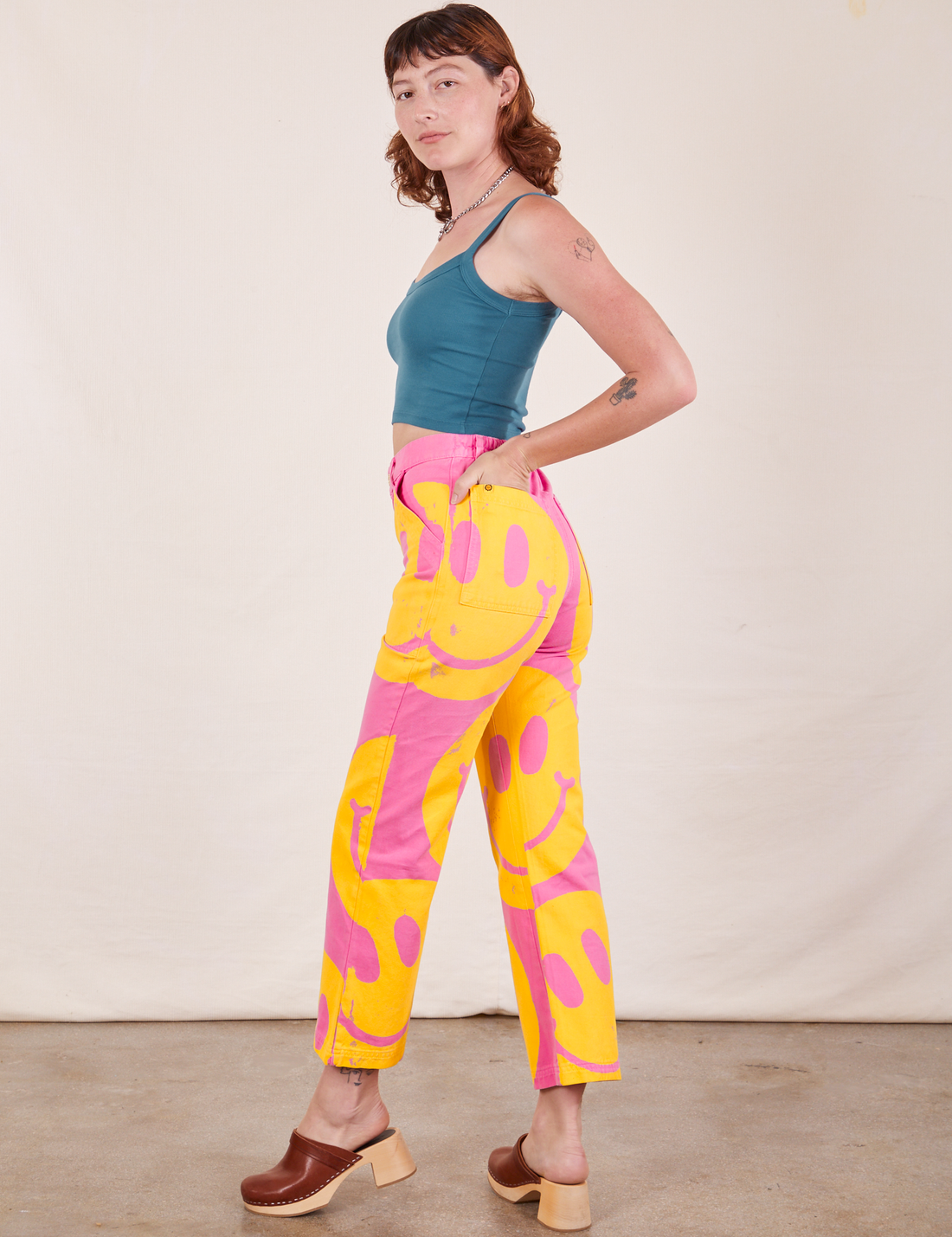 Side view of Icon Work Pants in Smilies and marine blue Cropped Cami worn by Alex