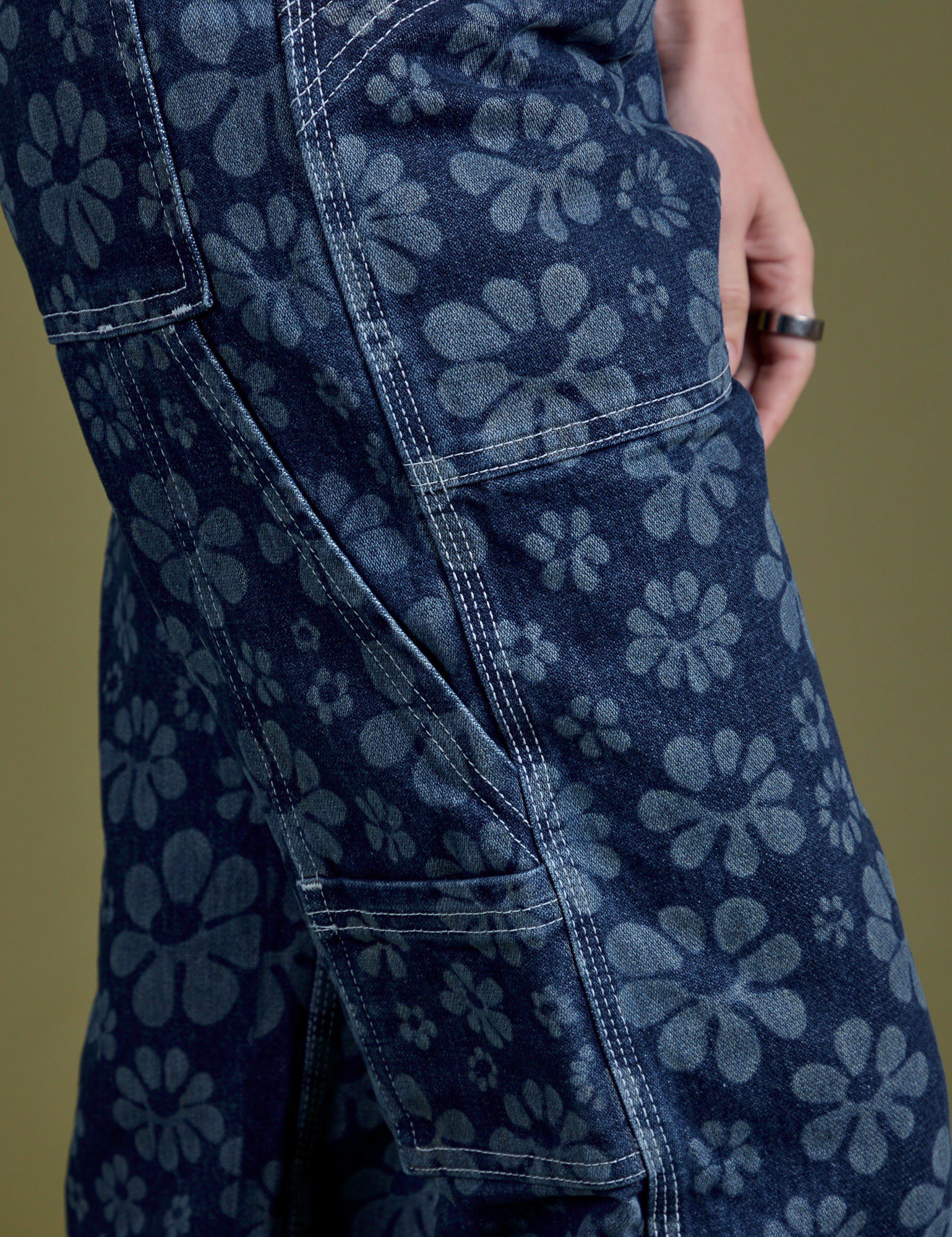 Close up side view of Lazy Daisy Mid-Rise Carpenter Jeans on Alex