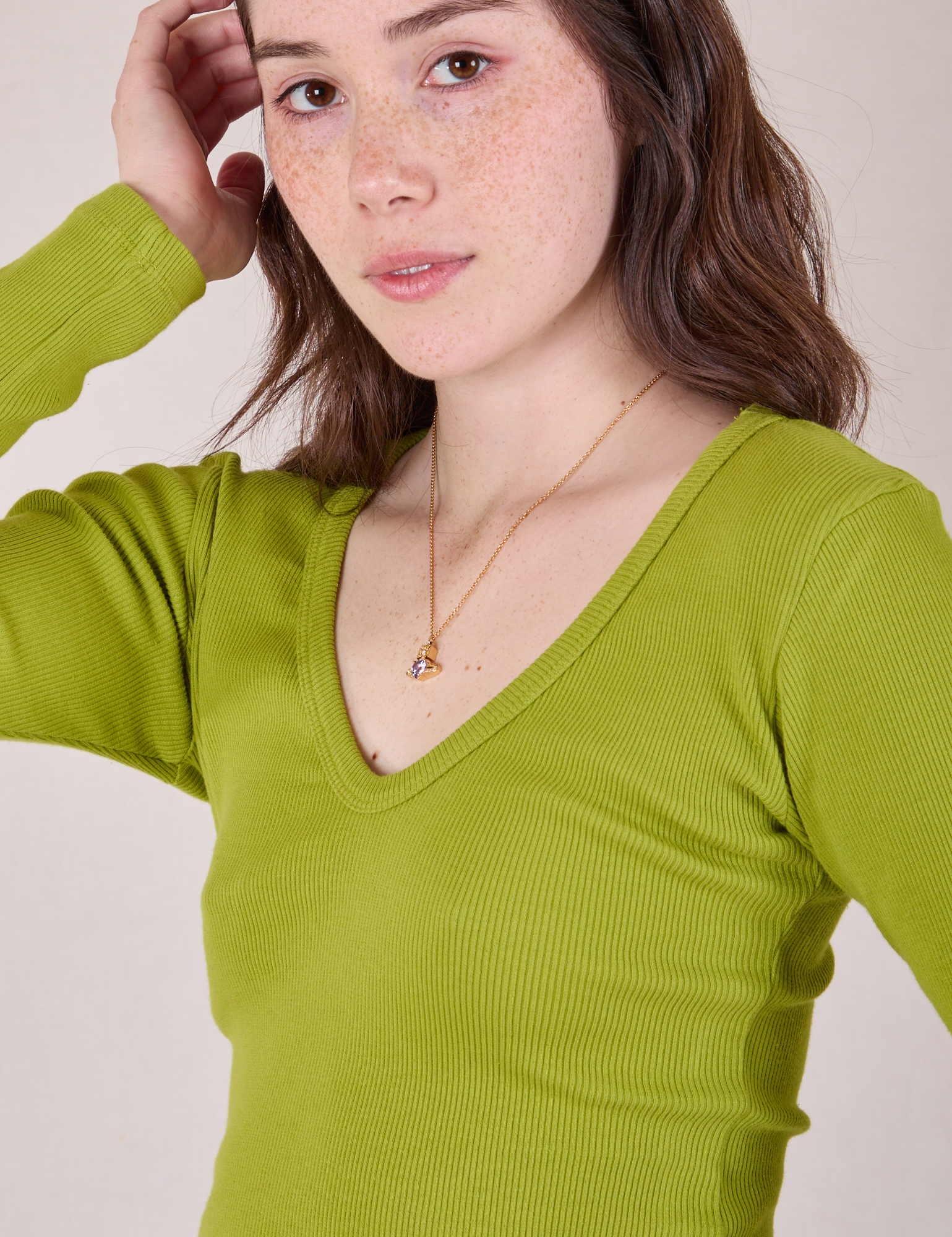 Close up of Long Sleeve V-Neck Tee in Gross Green on Hana