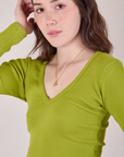 Close up of Long Sleeve V-Neck Tee in Gross Green on Hana