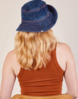 Back view of the Wide Brim Denim Bucket Hat in dark wash worn by Margaret