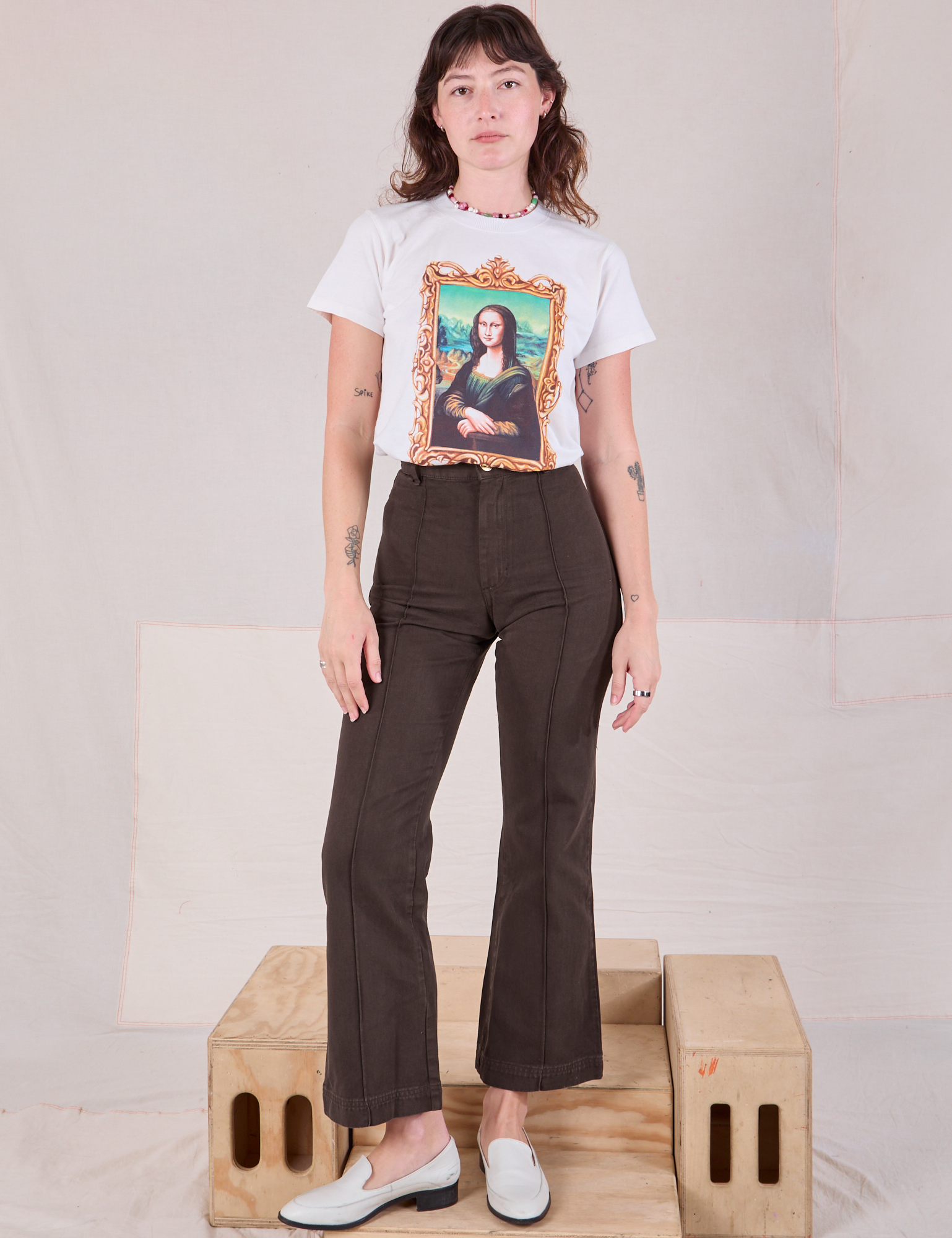 Alex is wearing Masters Organic Tee in Mona Lisa tucked into espresso brown Western Pants