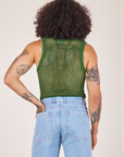 Back view of Mesh Tank Top in Lawn Green and light wash Sailor Jeans worn by Jesse.