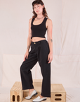 Angled front view of Mid-Rise Pleated Trousers in Basic Black and black Cropped Tank on Alex