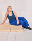 Juliet is wearing Mid-Rise Pleated Trousers in Royal Blue and lagoon Cropped Tank