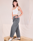 Side view of Mid-Rise Pleated Trousers in Slate Grey and Cropped Tank in vintage tee off-white