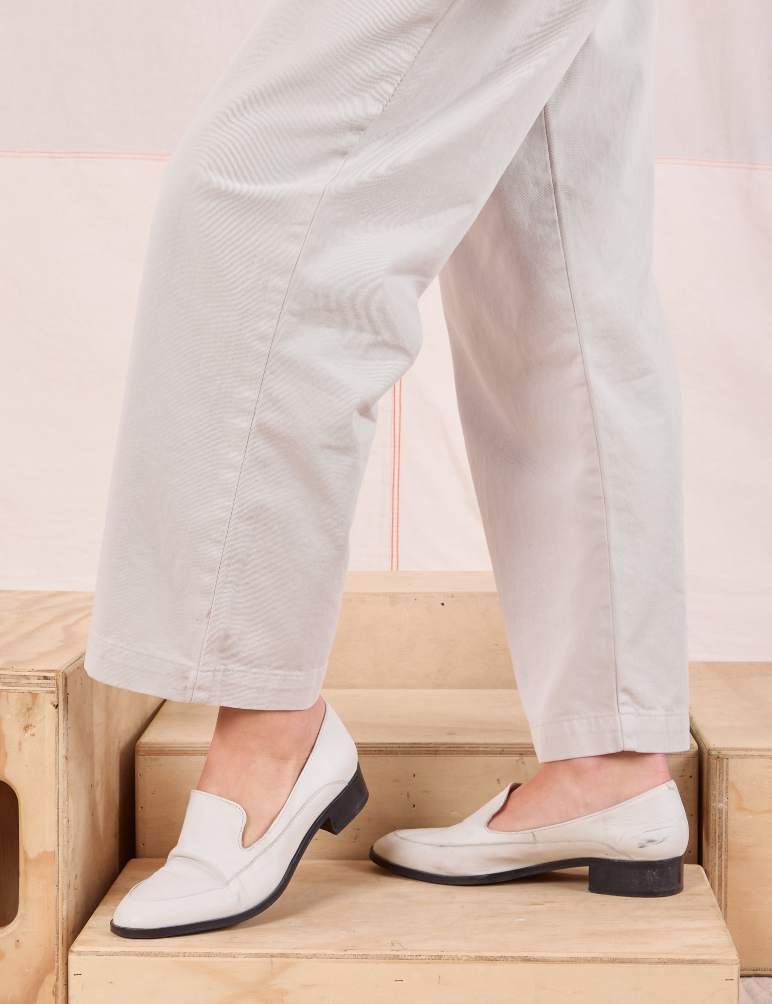 Mid-Rise Pleated Trousers in Stone White pant leg close up on Alex