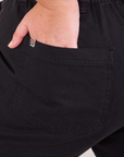 Mid-Rise Work Pants in Basic Black close up of Juliet's hand in the back pocket