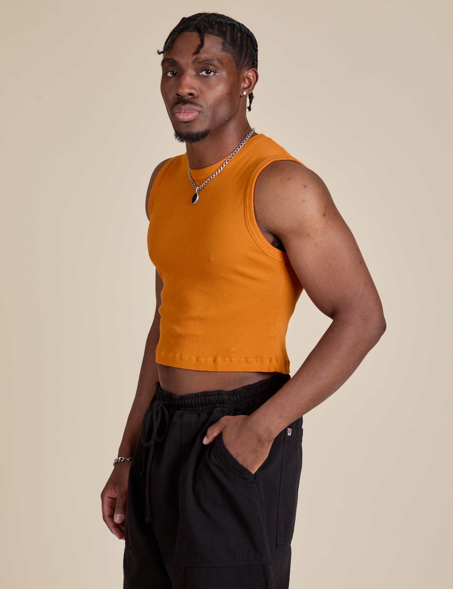 Angled front view of Muscle Tee in Creamsicle Orange on Isaac