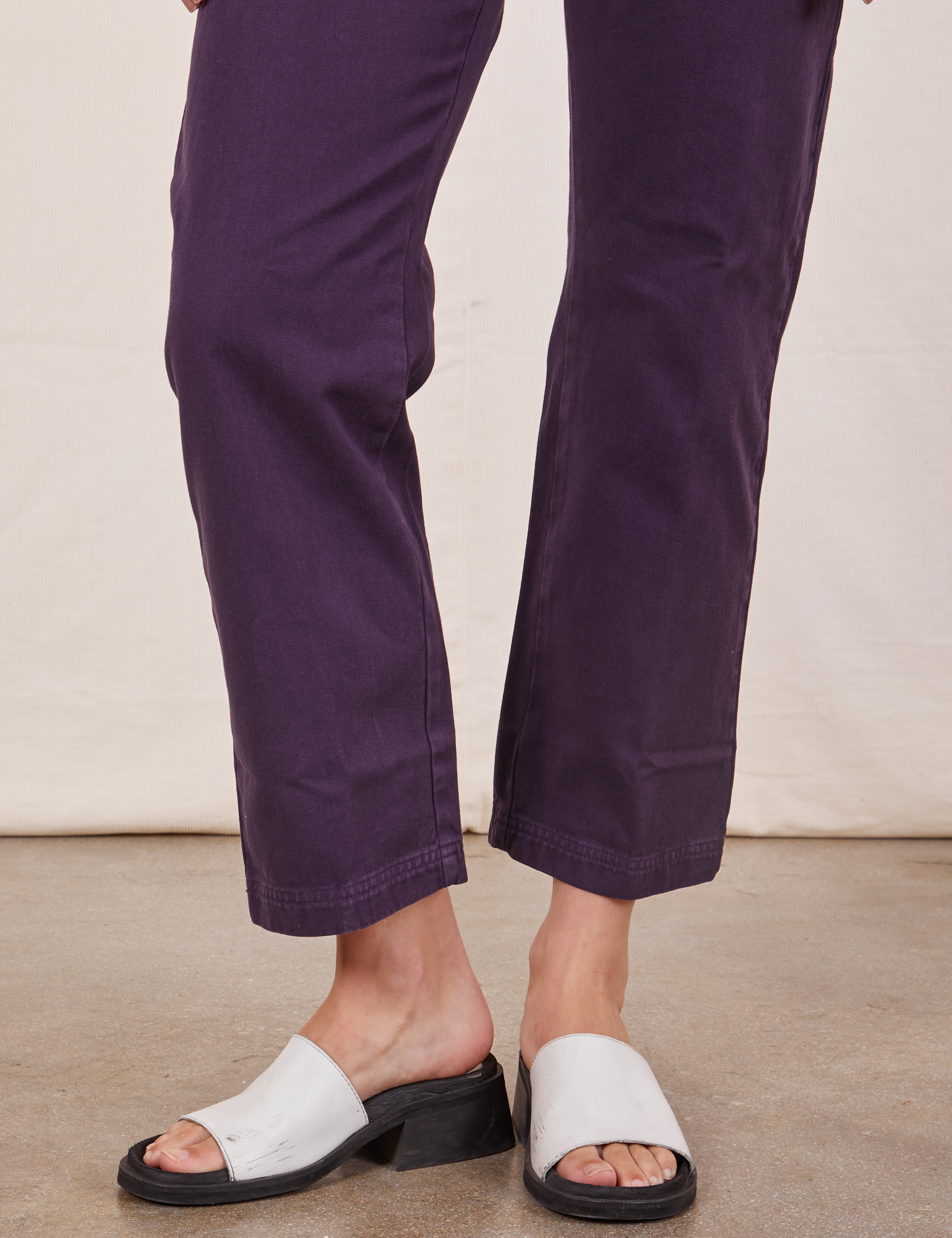 Pant leg close up of Short Sleeve Jumpsuit in Nebula Purple worn by Alex