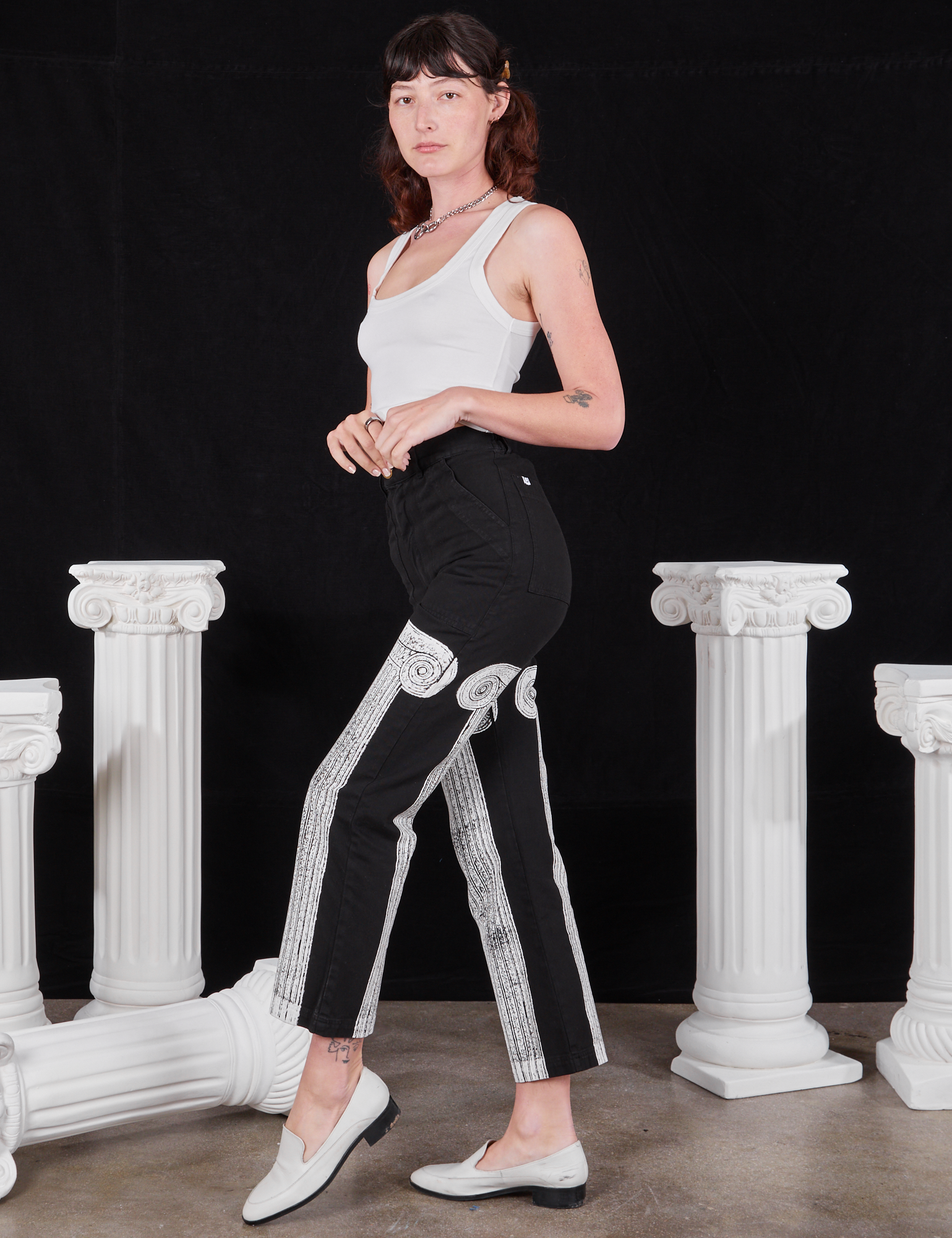 Side view of Column Work Pants in Basic Black and vintage off-white Cropped Tank Top on Alex