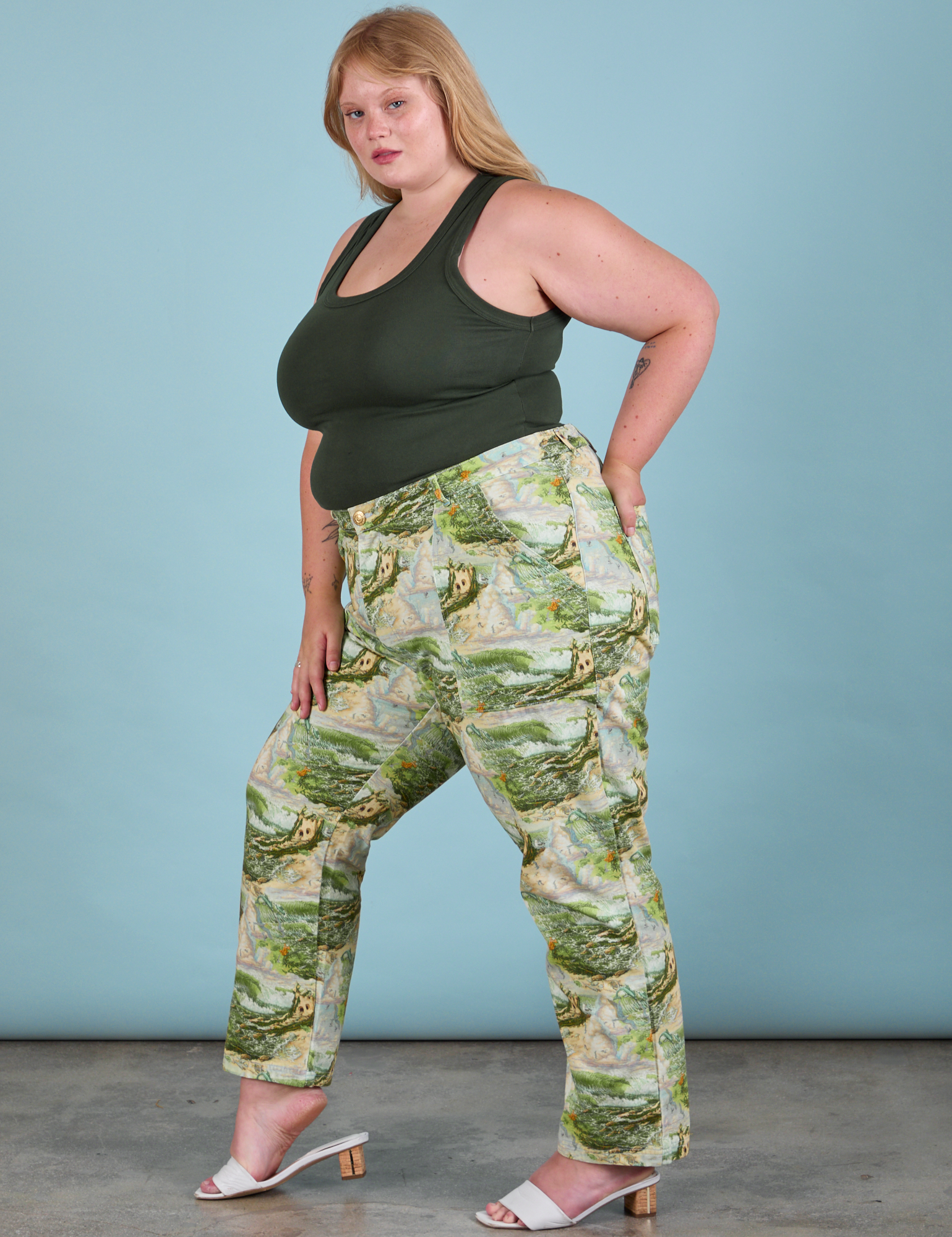 Side view of Work Pants in Ocean and Sky and swamp green Tank Top on Juliet