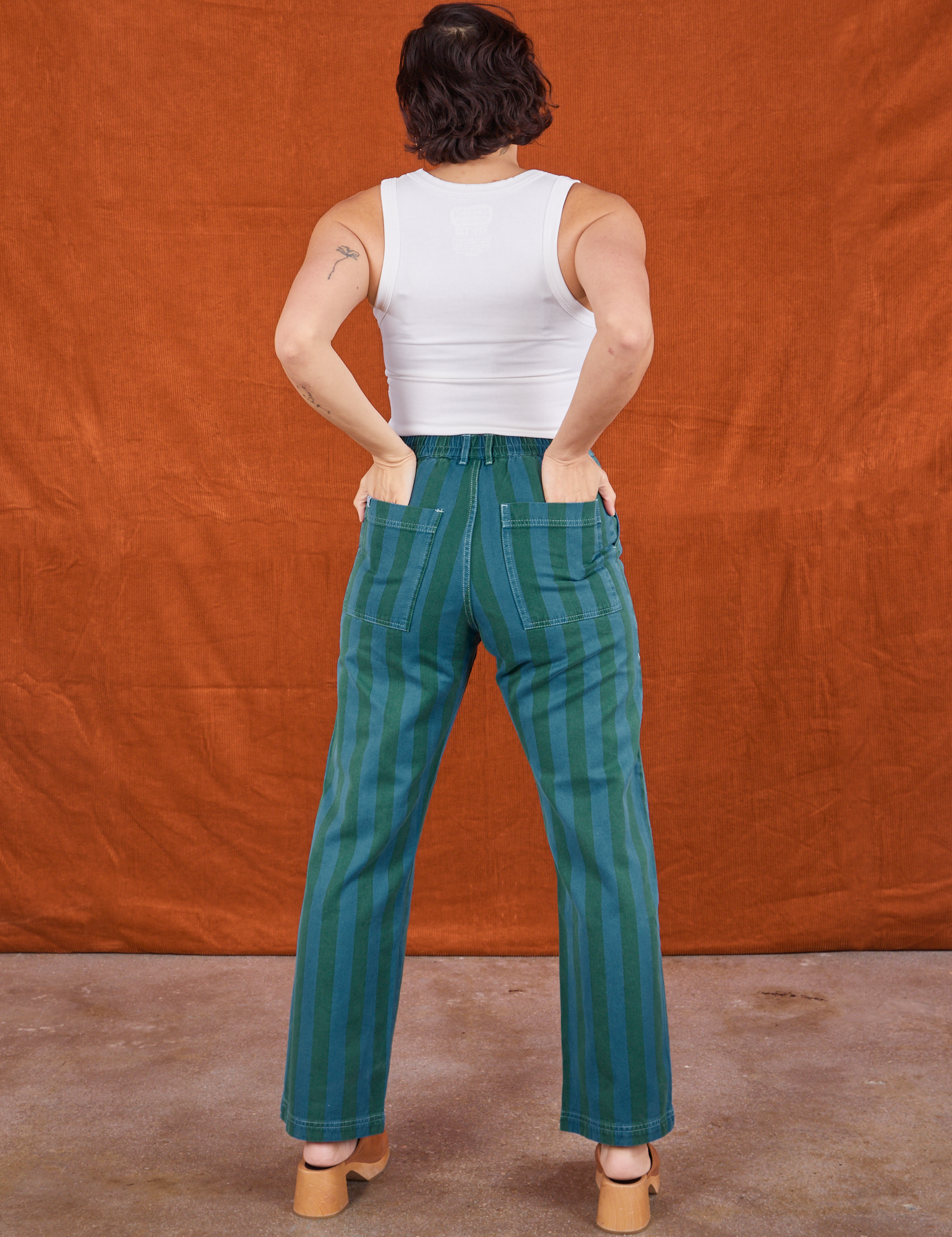 Back view of Overdye Stripe Work Pants in Blue/Green and vintage off-white Cropped Tank Top on Tiara