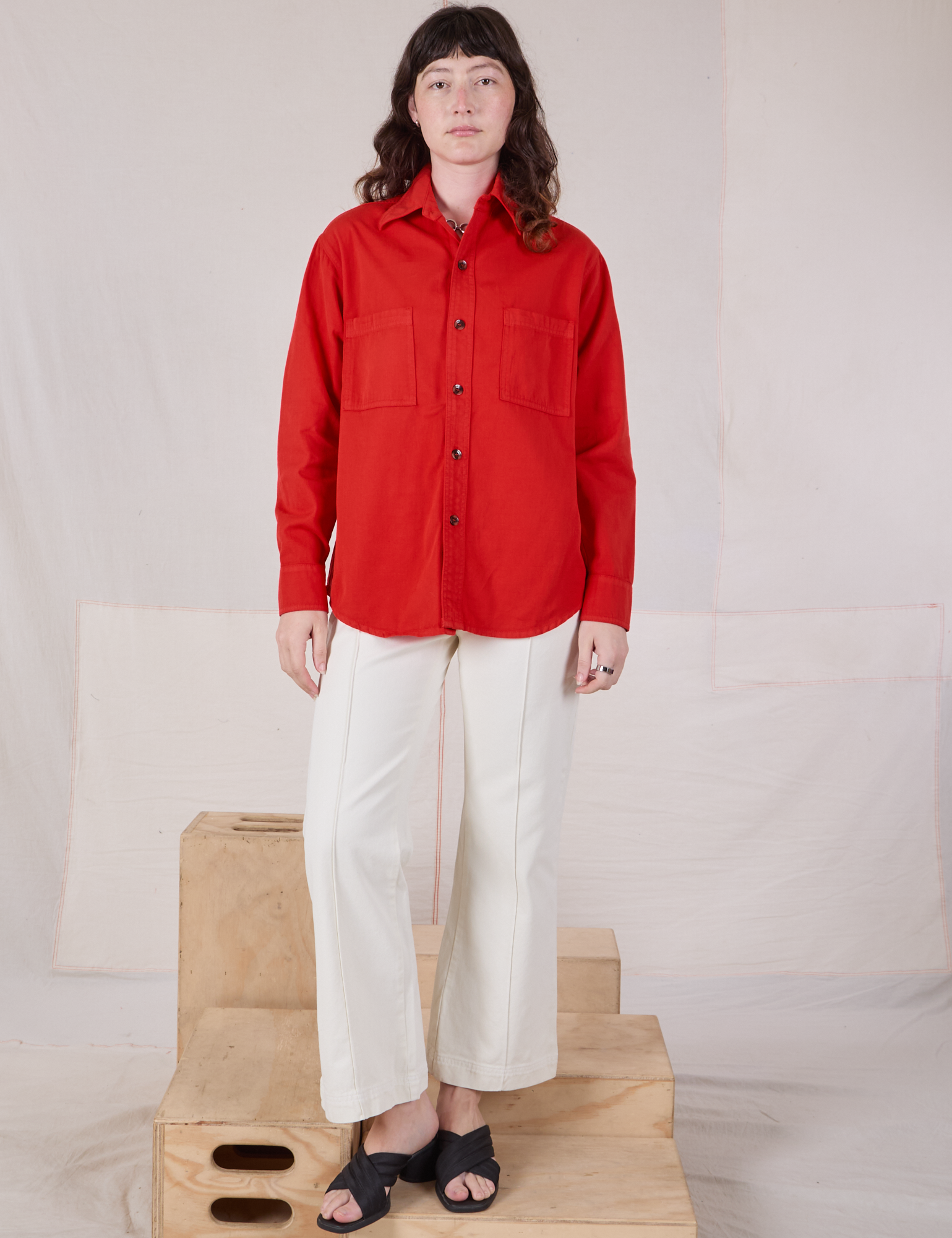 Alex is wearing Twill Overshirt in Mustang Red paired with vintage tee off-white Western Pants