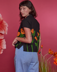 Angled back view of Paintstamped Pantry Button-Up in Poppy on Alex