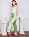 Side view of Hand-Painted Stripe Western Pants in Bright Olive paired with vintage off-white Tank Top worn by Alex. Baby blue and off-white hand painted stripe down the pant leg