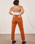 Back view of Pencil Pants in Burnt Terracotta and vintage off-white Halter Top worn by Tiara