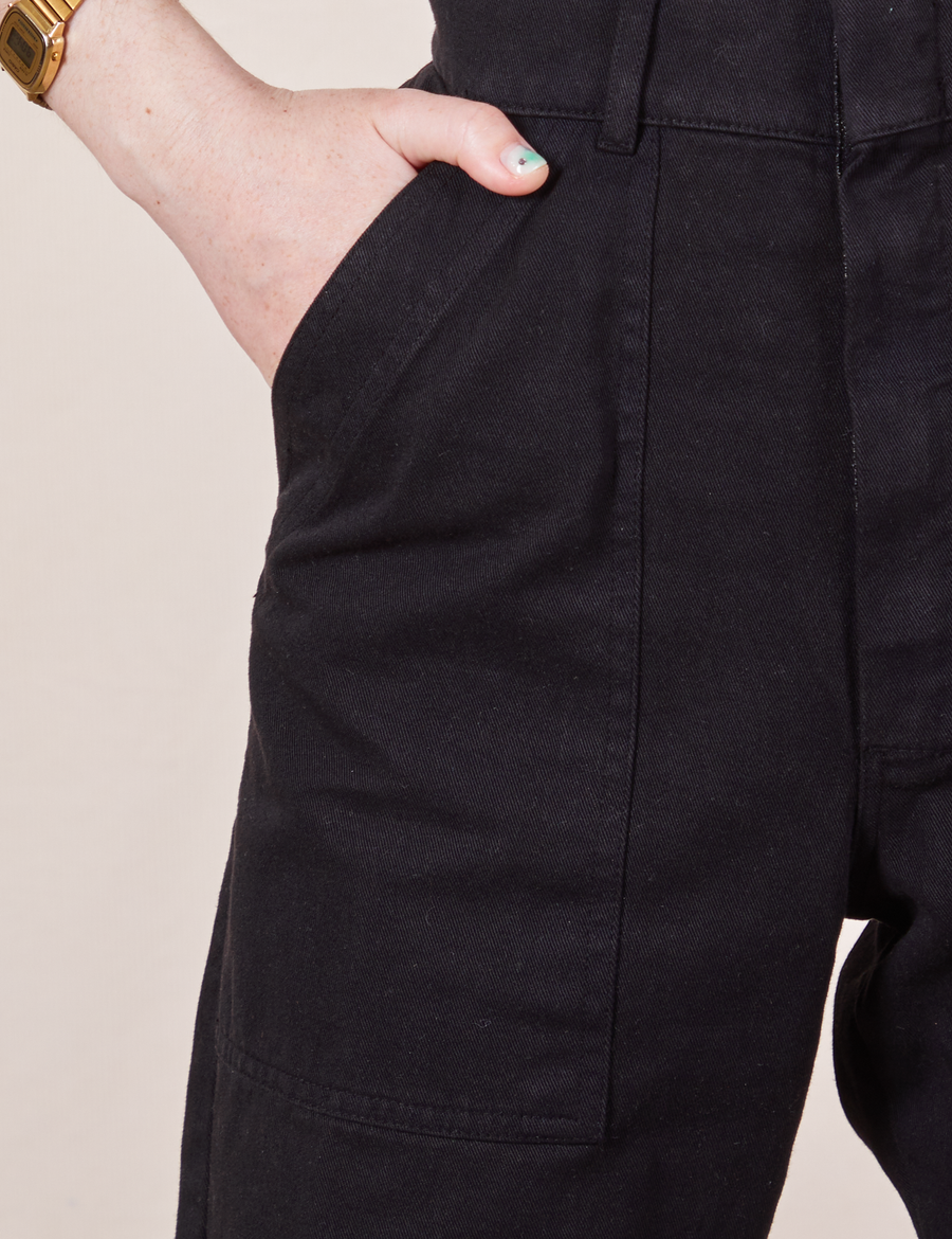 Front pocket close up of Petite Short Sleeve Jumpsuit in Basic Black worn by Hana