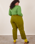 Work Pants in Olive Green back view on Morgan wearing bright olive Long Sleeve V-Neck Tee
