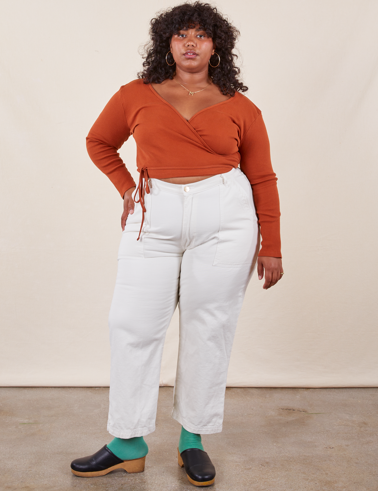 Morgan is 5&#39;5&quot; and wearing Petite 1XL Work Pants in Vintage Off-White paired with burnt terracotta Wrap Top