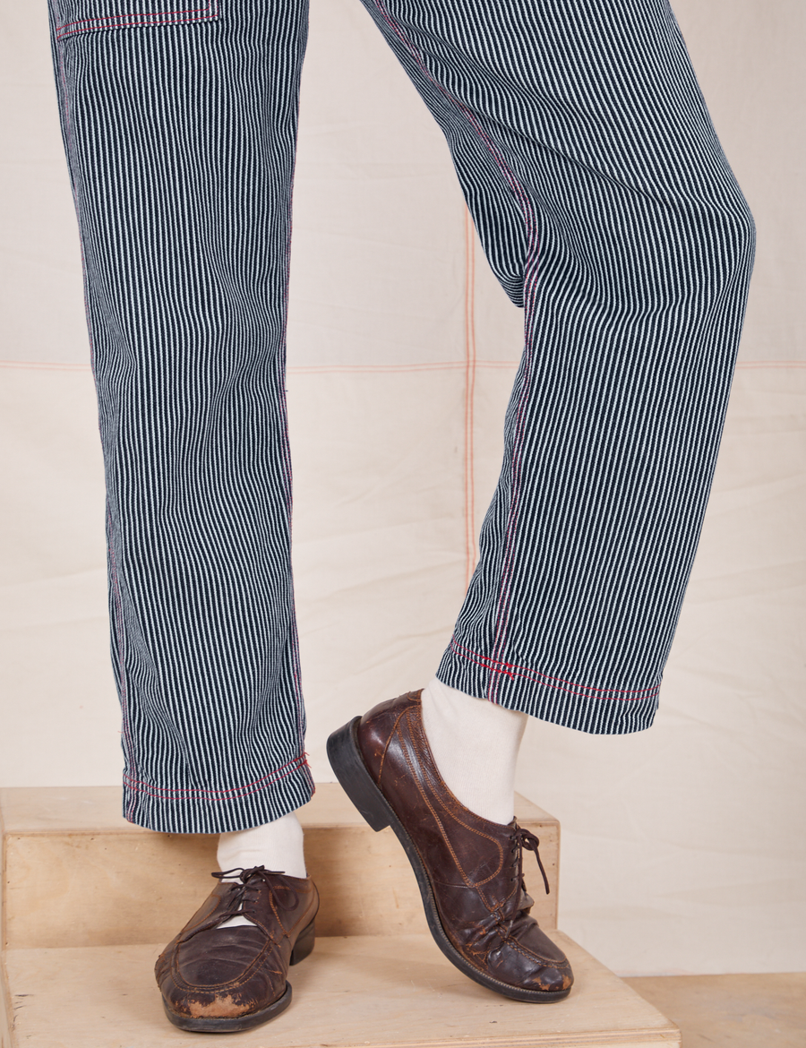 Pant leg close up of Railroad Stripe Denim Original Overalls worn by Jesse