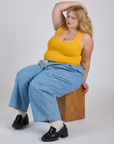 Juliet is wearing Cropped Tank Top in Sunshine Yellow and light wash Denim Drop Pocket Pants