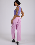 Angled back view of Drop Pocket Cargo Pants in Lilac Purple and faded grape Cropped Tank on Kira