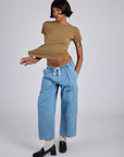 Kira is wearing Jr. Varsity Tee in Desert Brown and light wash Denim Drop Pocket Pants