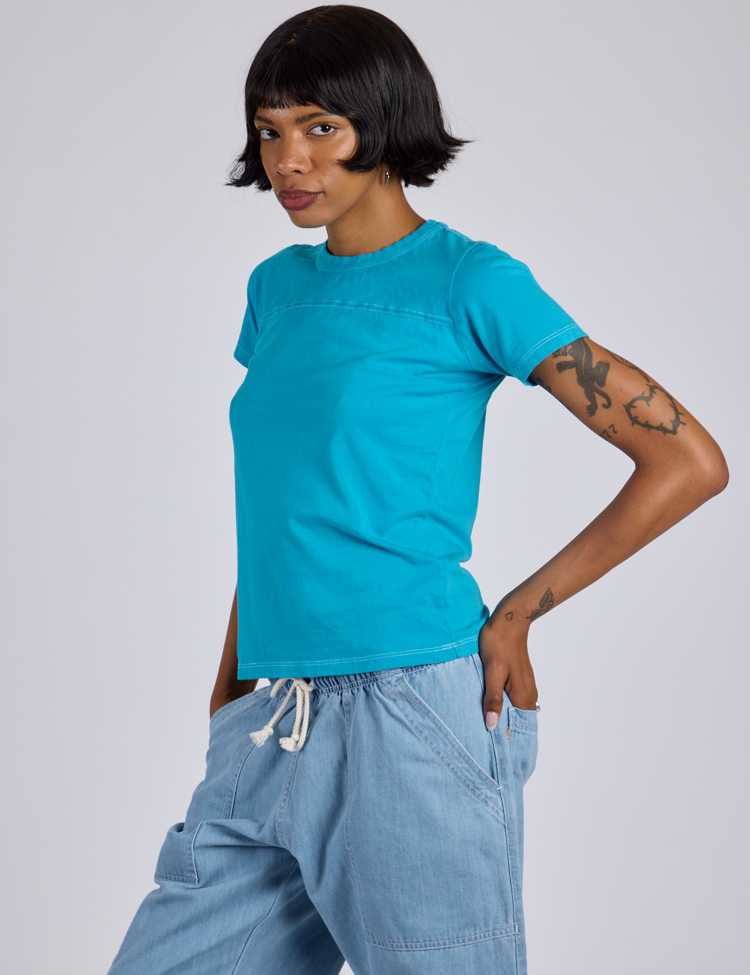 Angled front view of Jr. Varsity Tee in Hawaiian Blue on Kira