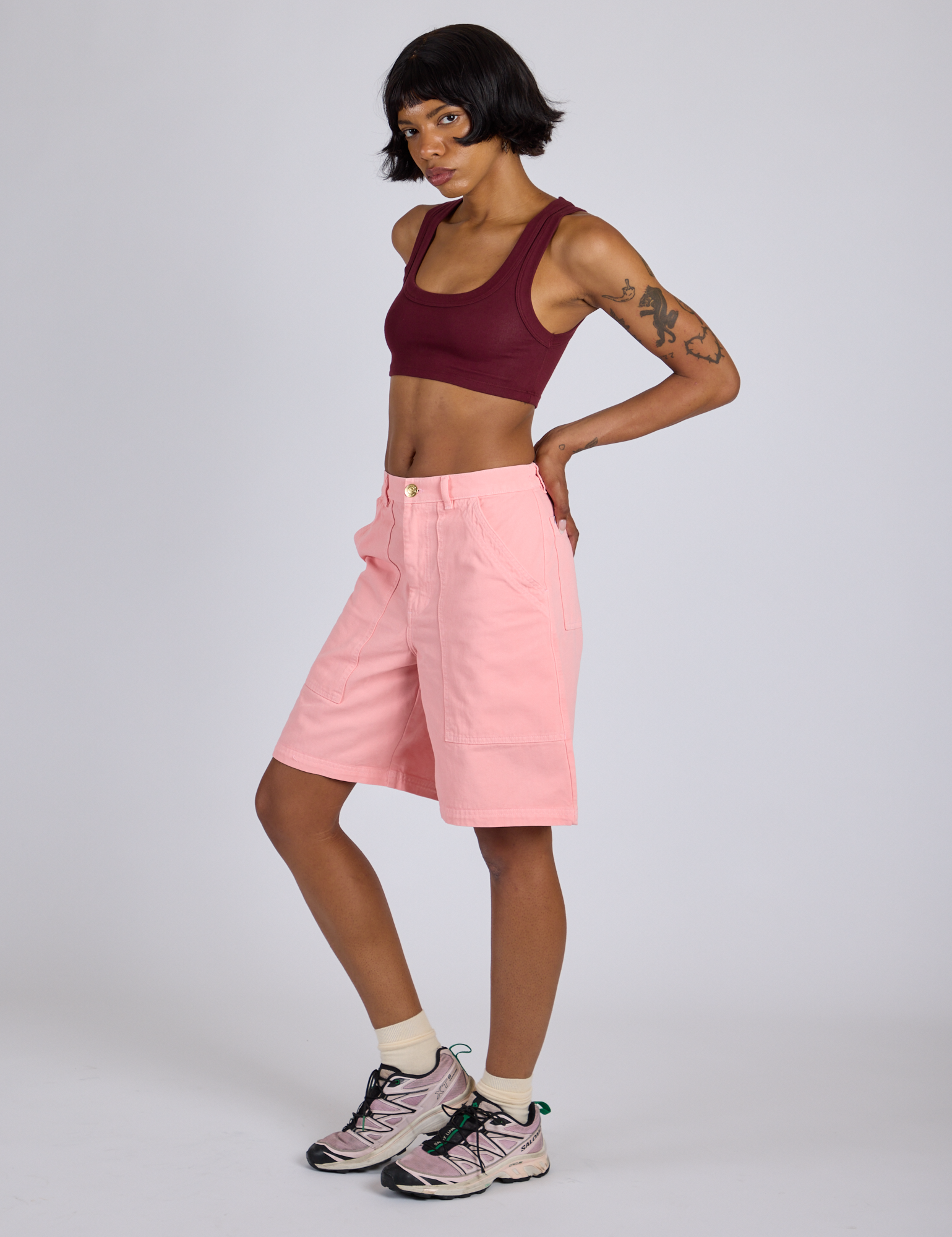 Angled front view of Longline Work Shorts in Baby Pink and red wine Mini Tank