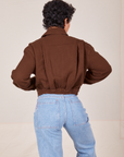 Back view of Ricky Jacket in Fudgesicle Brown and light wash Sailor Jeans worn by Mika