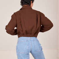 Back view of Ricky Jacket in Fudgesicle Brown and light wash Sailor Jeans worn by Mika