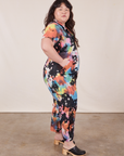 Side view of Petite Short Sleeve Jumpsuit in Rainbow Magic Waters worn by Ashley