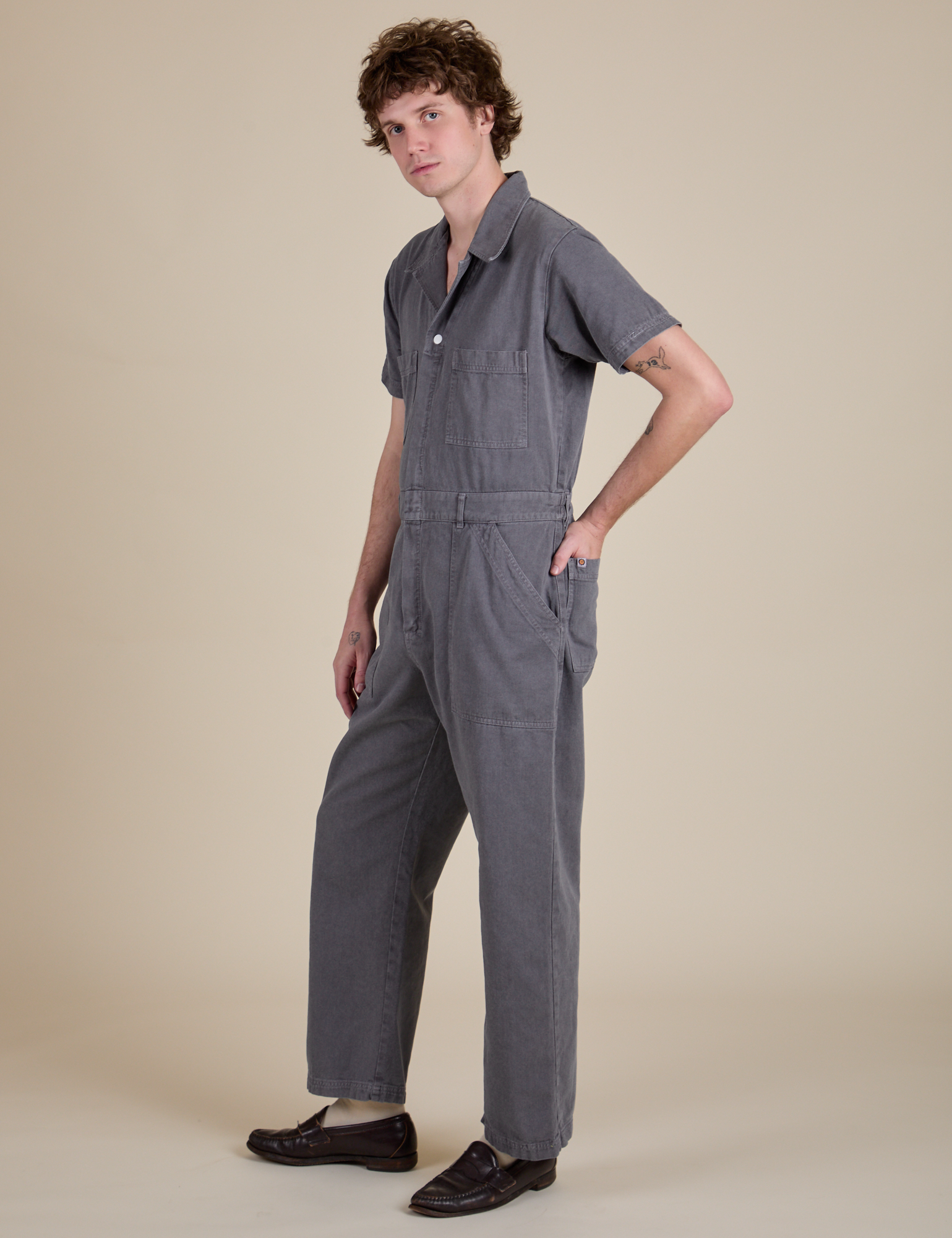 Angled front view of Short Sleeve Jumpsuit in Washed Grey on Quinn