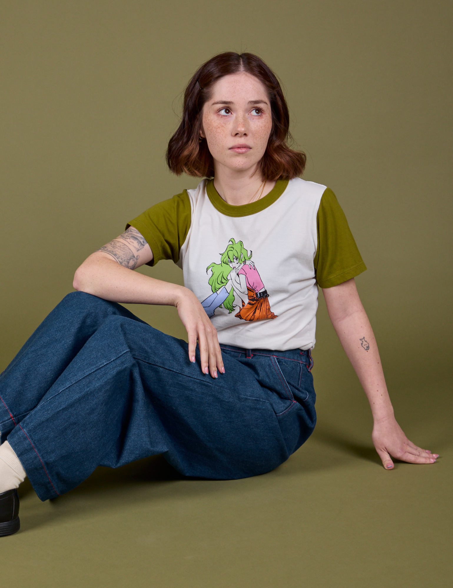 Hana is wearing Olive Lottie Tee