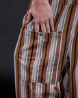 Close up of Alex's hand in the Striped Drop Pocket Pants in Retro Rainbow pant leg pocket 