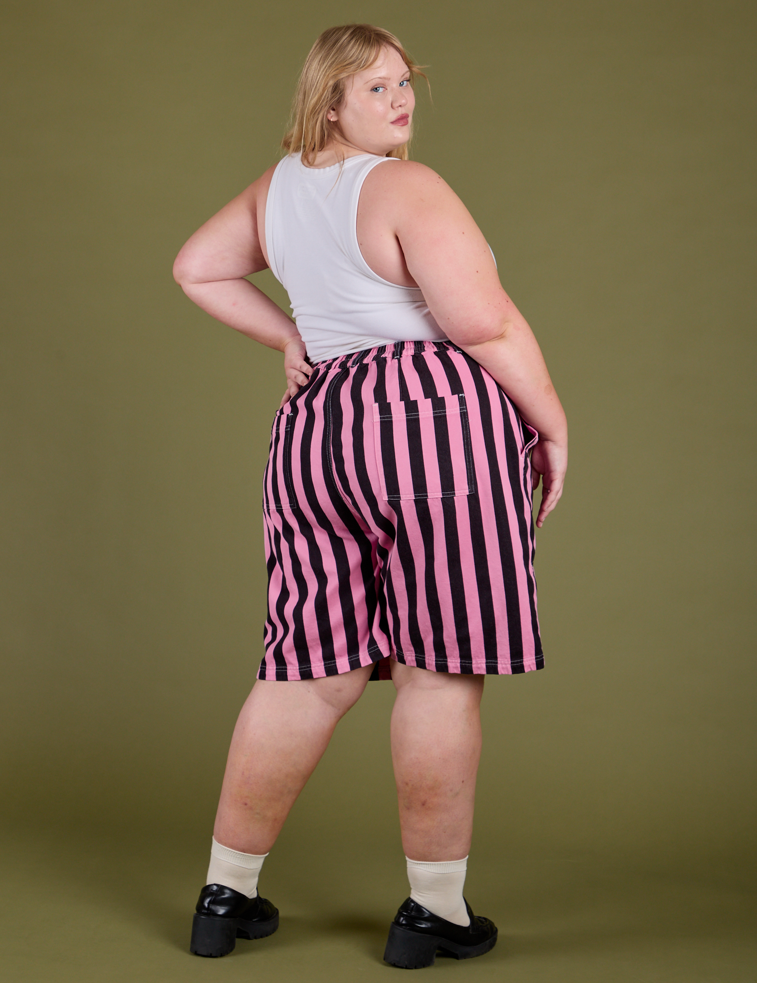 Angled back view of Longline Work Shorts in Bubblegum Pink on Juliet