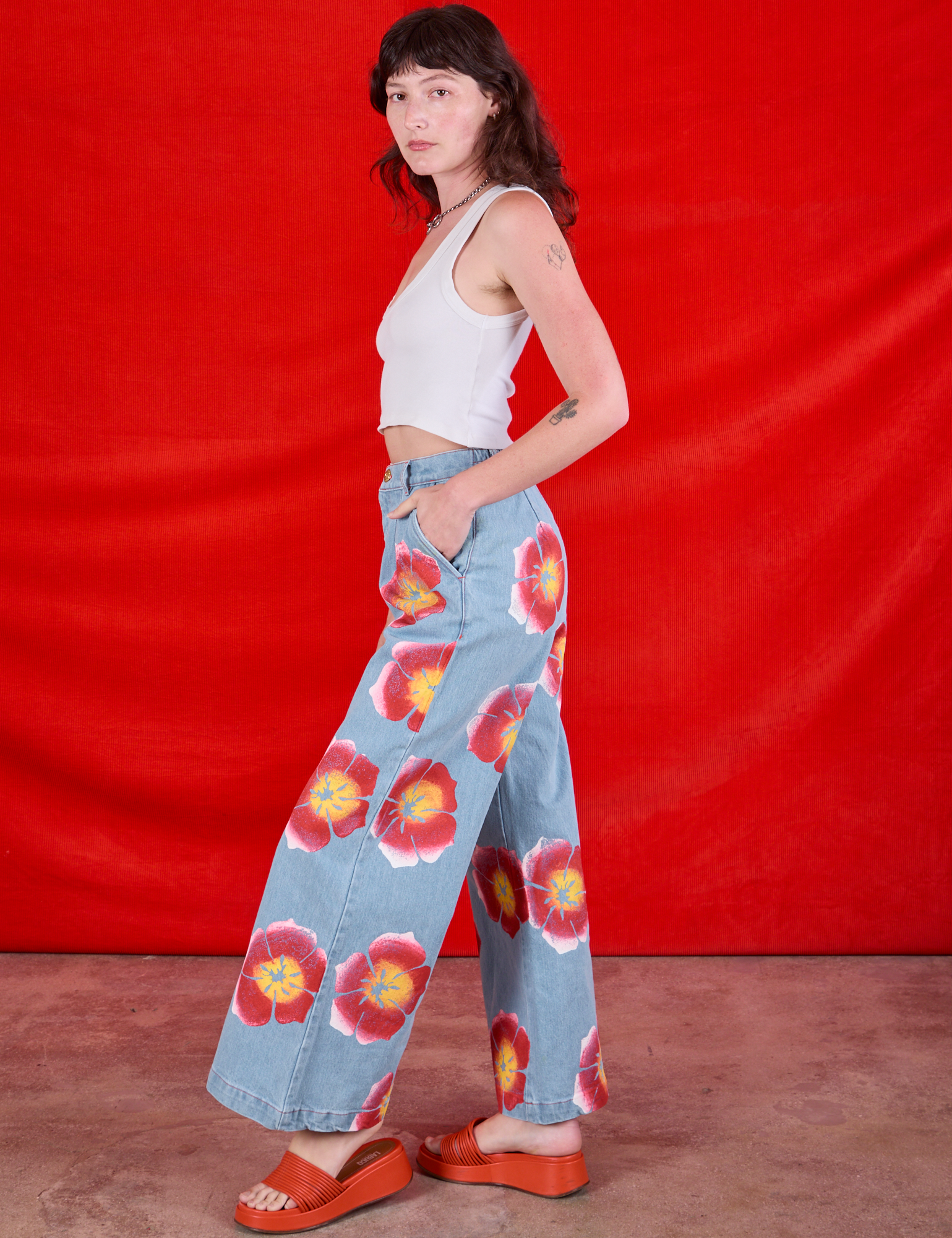 Side view of Wide Leg Denim Trousers in Painted Flowers and Cropped Tank in Vintage Tee Off-White