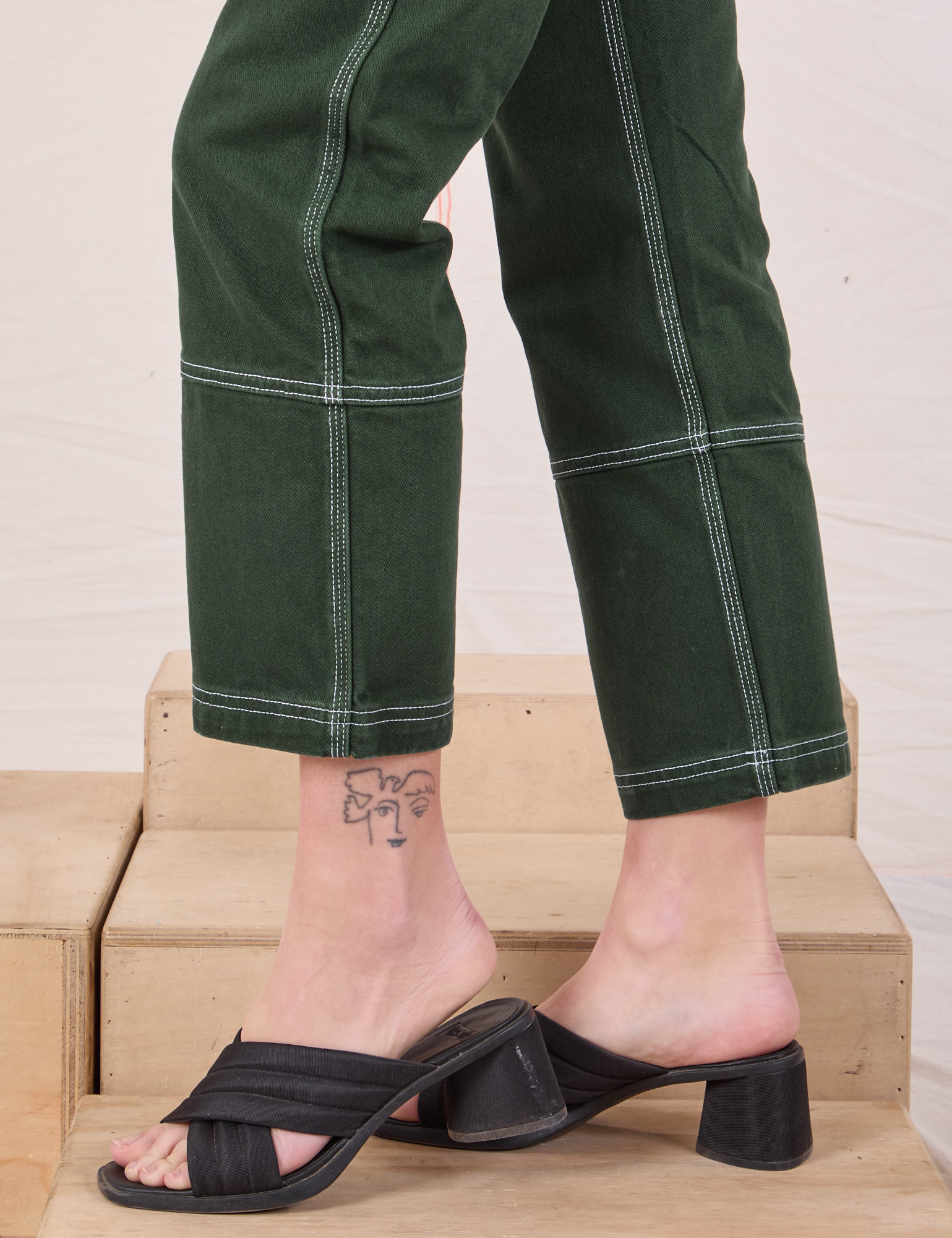 Carpenter Jeans in Swamp Green side pant leg close up on Alex