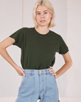 Madeline is wearing Organic Vintage Tee in Swamp Green tucked into light wash Carpenter Jeans