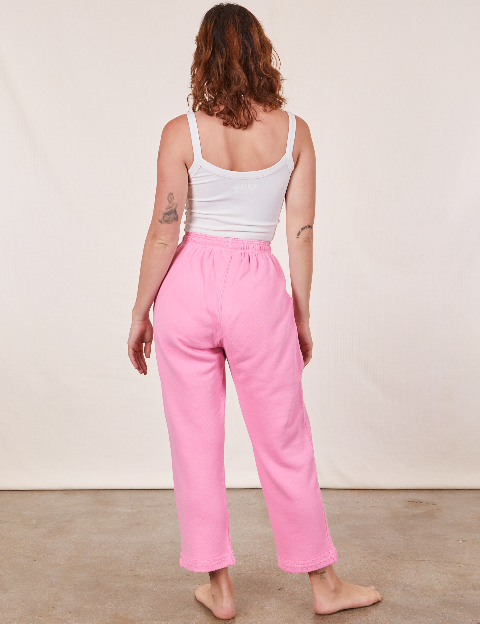 Back view of Cropped Rolled Cuff Sweatpants in Bubblegum Pink and vintage off-white Cami on Alex