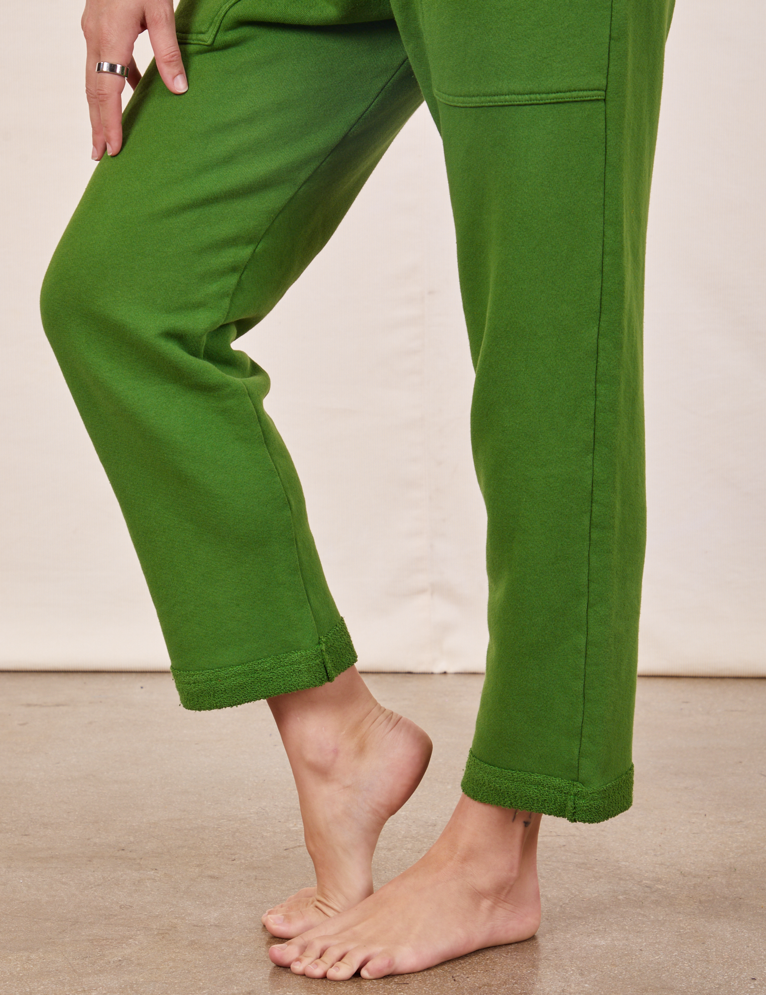 Cropped Rolled Cuff Sweatpants in Lawn Green pant leg close up on Alex