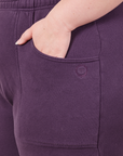 Cropped Rolled Cuff Sweatpants in Nebula Purple front pocket close up. Ashley has her hand in the pocket.