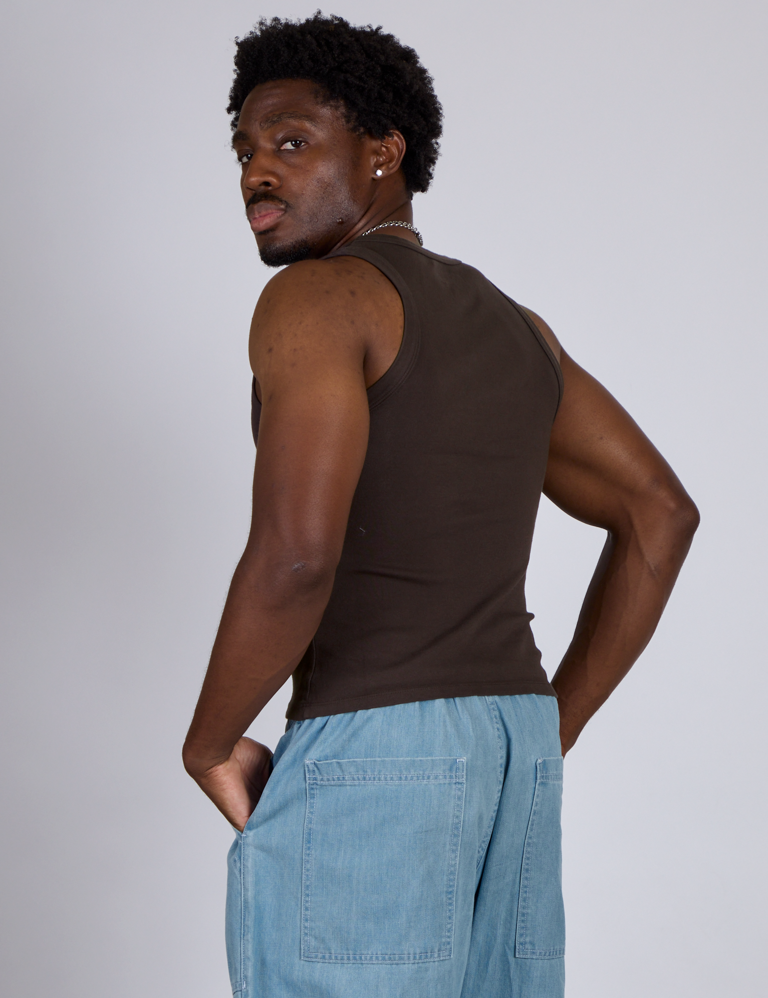 Angled back view of The Tank Top in Espresso Brown on Isaac