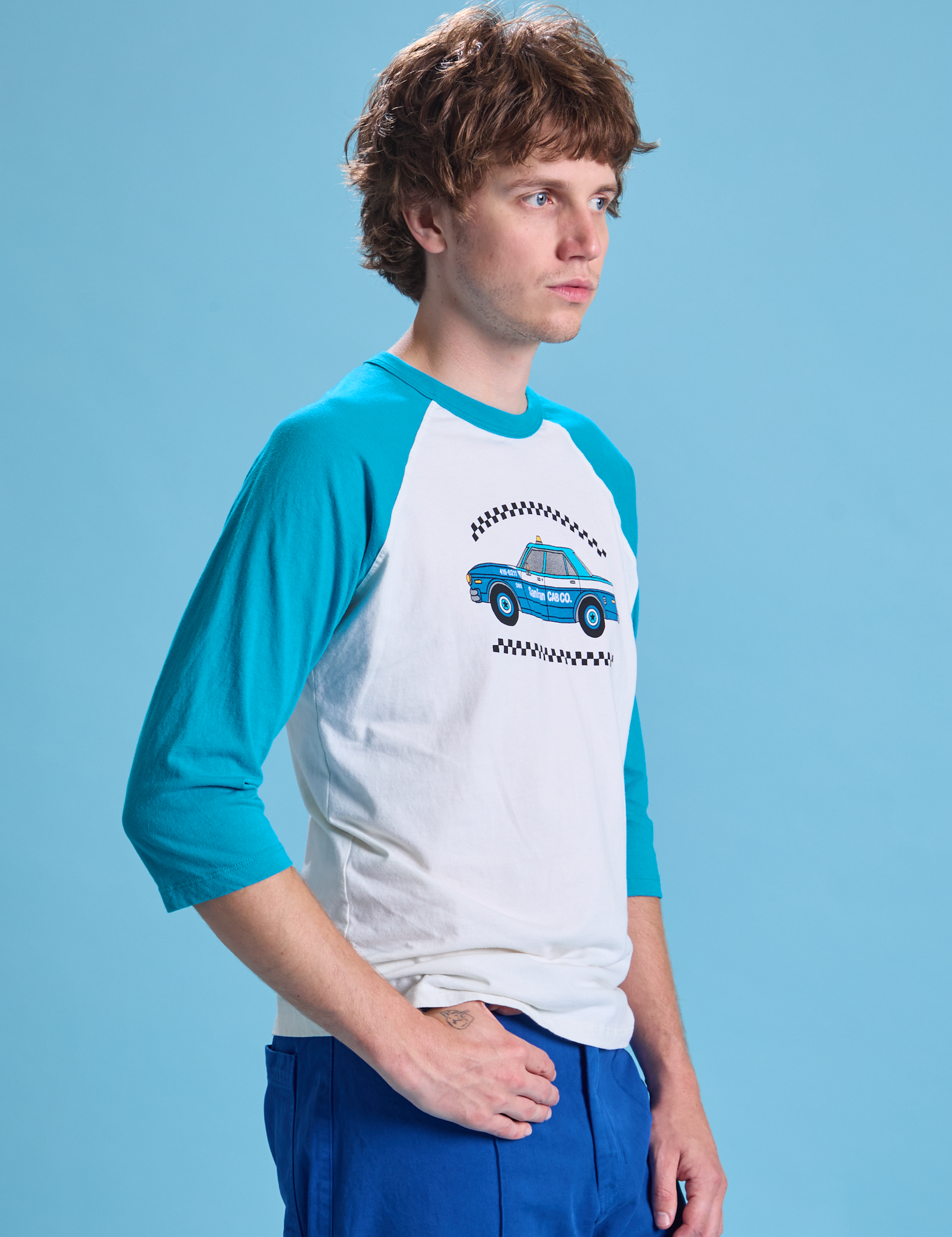 Taxi Raglan Tee in San Francisco angled front view on Quinn