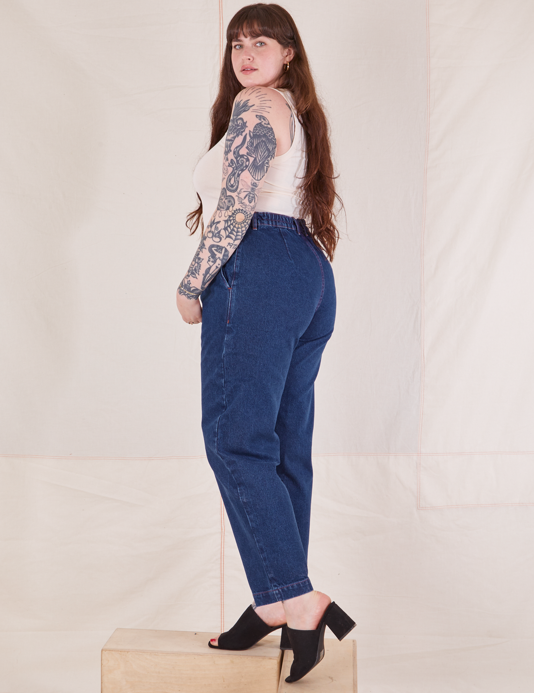Side view of Denim Trouser Jeans in Dark Wash and vintage off-white Tank Top worn by Sydney
