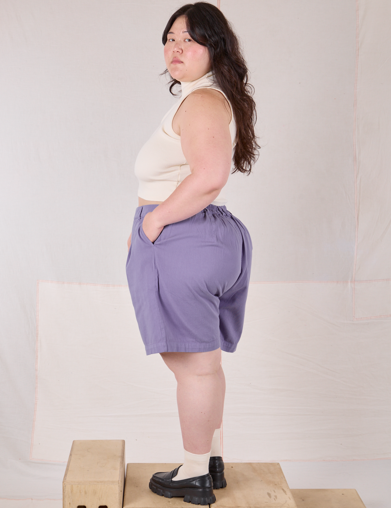Angled back view of Trouser Shorts in Faded Grape on Ashley