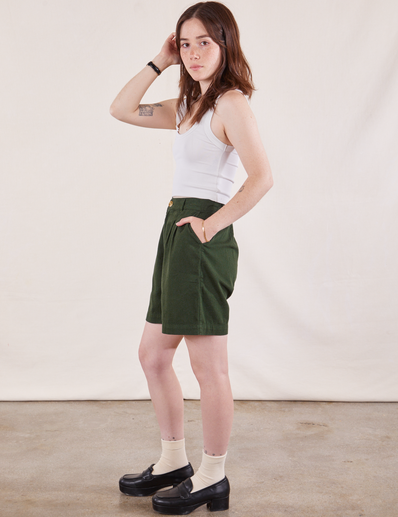 Side view of Trouser Shorts in Swamp Green and Cropped Tank in Vintage Tee Off-White on Hana