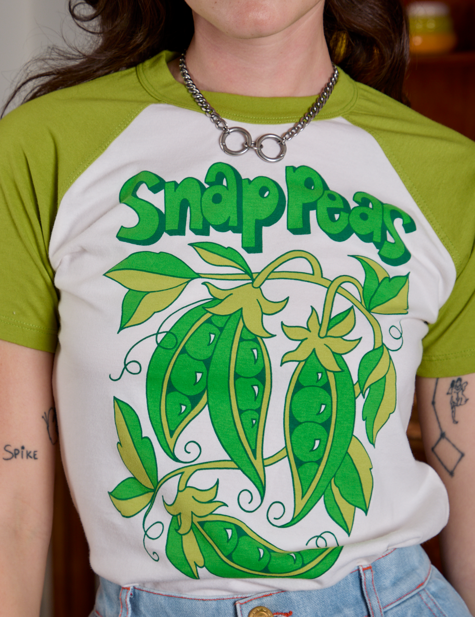 Short Sleeve Raglan Tee in Snap Peas front close up on Alex